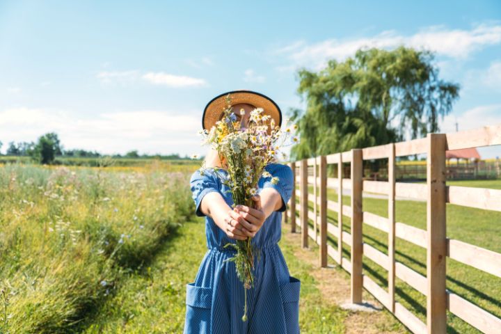 Girl With A Bouquet Of Flowers On A Farm