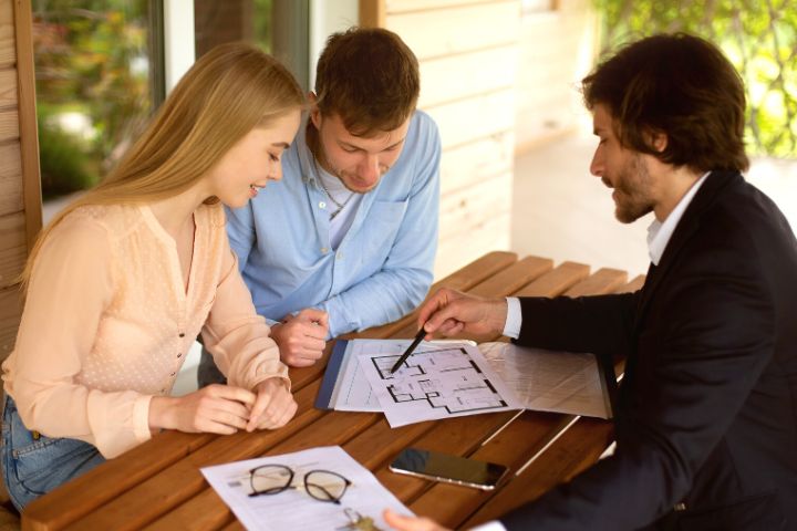 Manager Showing Flat Plan To His Clients